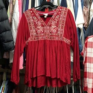 Red blouse with stitching.  Elastic on sleeves.